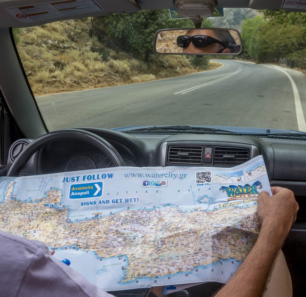 Map of Crete and people in four-wheel drive car